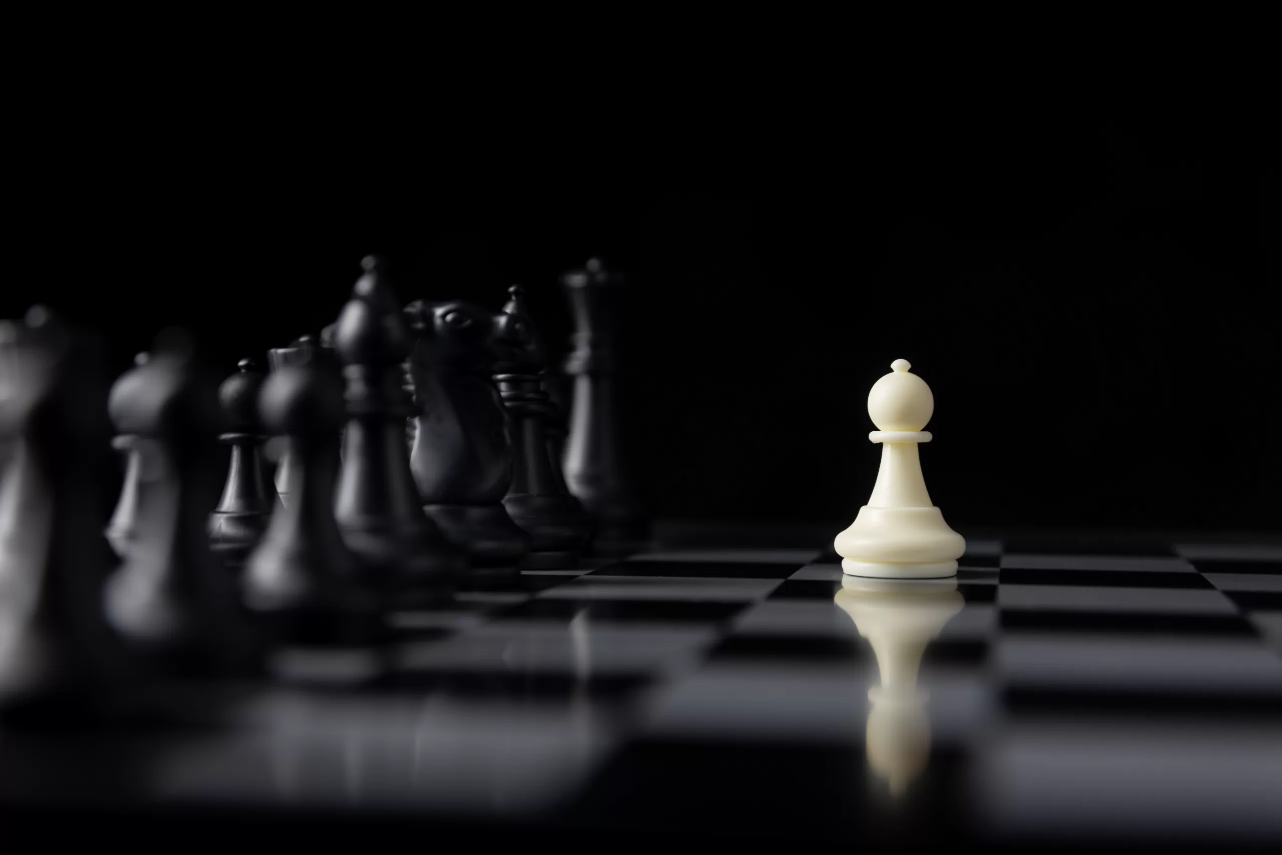 single white chess fight with lots of black pieces on board, tac