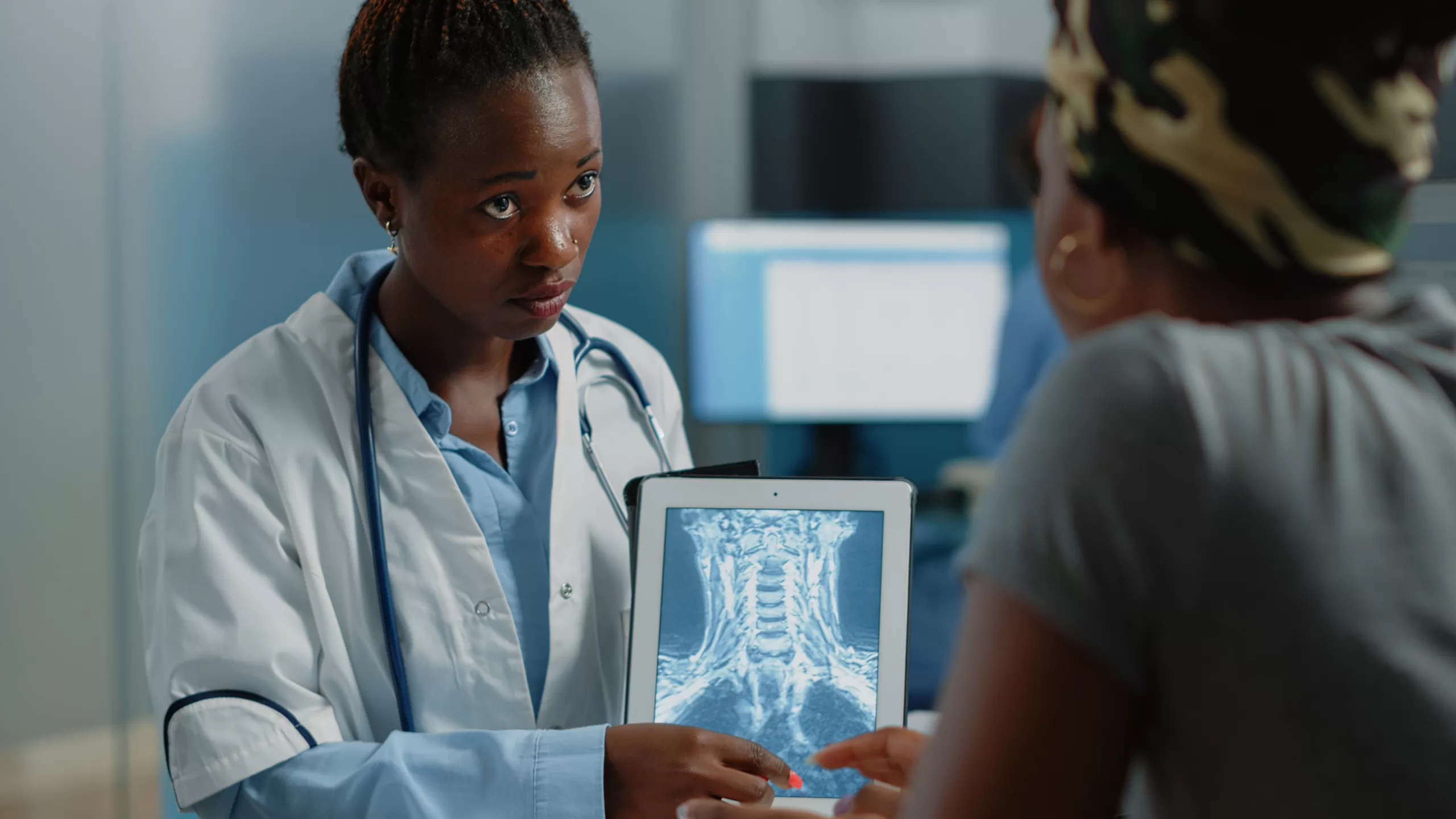 woman working as doctor with radiography on tablet