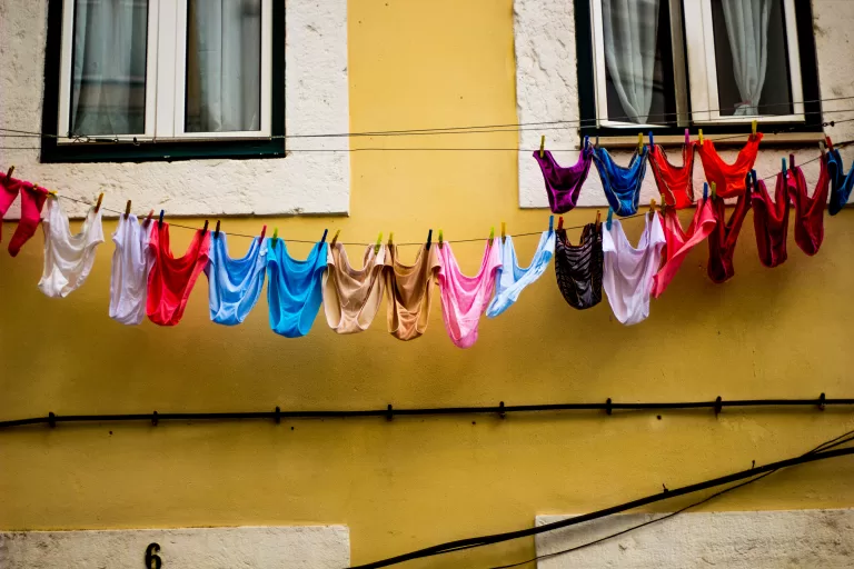 facade of a house with colorful underwear hanging on the laundry line