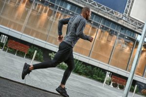 Healthy habits. Full length of young and athletic african man in stylish sportswear running in the
