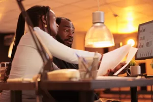 team of office employees working together on paperwork report